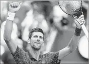  ?? JUSTIN LANE/EPA ?? Novak Djokovic celebrates after claiming a 6-3, 6-4, 6-3 victory in the fourth round of the U.S. Open on Monday.