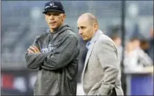  ?? KATHY WILLENS — THE ASSOCIATED PRESS FILE ?? Yankees manager Joe Girardi, left, and general manager Brian Cashman chat on the field before American League wild-card playoff game last month.