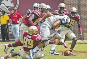  ??  ?? Brian Burns (99) and Florida State’s defense will be charged with trying to stop Louisville and quarterbac­k Lamar Jackson on Saturday.