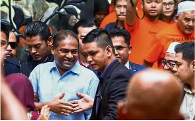  ??  ?? Staunch support: Abdul Azeez being greeted by supporters upon his release at the magistrate’s court in Putrajaya.