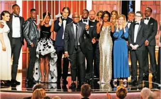  ??  ?? This image released by NBC shows Adele Romanski, foreground center, with the cast and crew of ‘Moonlight,’ accepting the award for best motion picture drama.