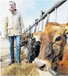  ?? THE ASSOCIATED PRESS ?? Former Republican presidenti­al candidate Mitt Romney stands next to cows during a tour Friday at Gibson’s Green Acres Dairy in Ogden, Utah.