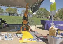  ??  ?? ABOVE: Joe Lewis does yoga Saturday during the Rally for Recovery. He is part of a recovery group that practices yoga.