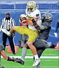  ?? Pittsburgh Post-Gazette via AP - Matt Freed ?? Notre Dame tight end Michael Mayer pulls in a touchdown pass against Pittsburgh’s Paris Ford during last week’s game.