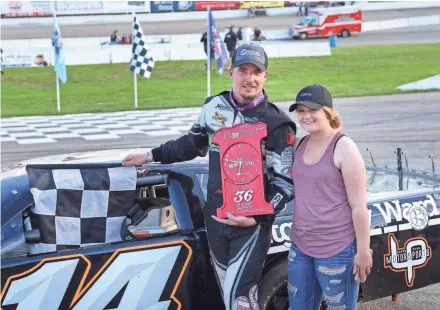  ?? DAVE KALLMANN / MILWAUKEE JOURNAL SENTINEL ?? Illinois racer Austin Nason and his girlfriend, Taylor Colvin, pose in victory lane after he won the ARCA Midwest Tour Joe Shear Classic on Sunday at Madison Internatio­nal Speedway.