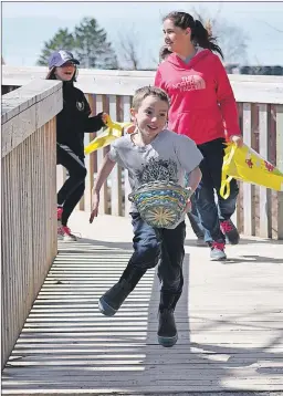  ?? ASHLEY THOMPSON ?? How does it feel to be the leader of the pack at the community Easter egg hunt? His expression says it all.