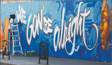  ?? (File Photo/The Canadian Press/Adrian Wyld) ?? Artist Jimmy Baptiste works July 10 on a mural in Ottawa.