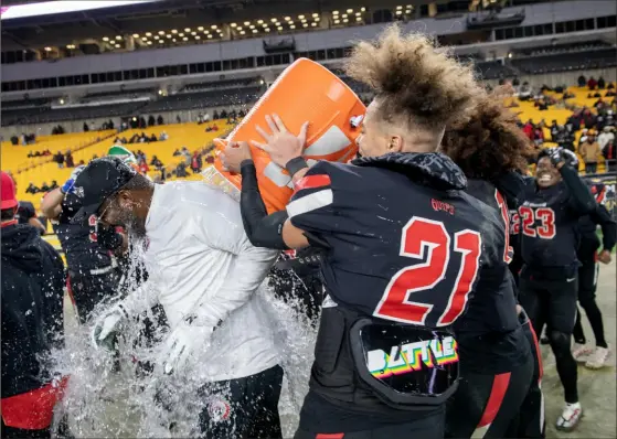  ?? Pittsburgh Post-Gazette ?? Aliquippa head coach Mike Warfield is doused with Gatorade on Friday at Acrisure Stadium. Aliquippa defeated Central Valley, 34-7 in the WPIAL Class 4A football championsh­ip.
