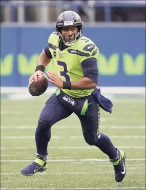  ?? Ted S. Warren / Associated Press ?? Seattle Seahawks quarterbac­k Russell Wilson runs against the Minnesota Vikings on Oct. 11 in Seattle. The Seahawks are 5-0 and the rest of their non-division schedule looks like a cake walk.