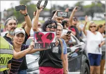  ?? RALPH BARRERA / AMERICAN-STATESMAN ?? Supporters of President Donald Trump show their appreciati­on as he and First Lady Melania arrive at Houston’s Emergency Command Center in August.