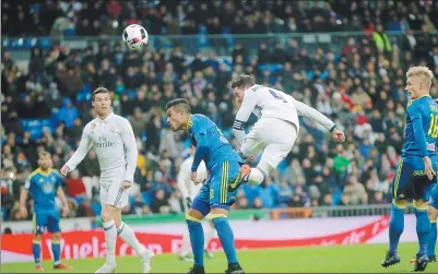  ?? PAUL WHITE / AP ?? Real Madrid’s Sergio Ramos goes up for a header during Wednesday’s 2-1 Spanish King’s Cup quarterfin­al, first-leg loss to Celta Vigo at Santiago Bernabeu stadium in Madrid. The return leg is in Vigo on Jan 25.