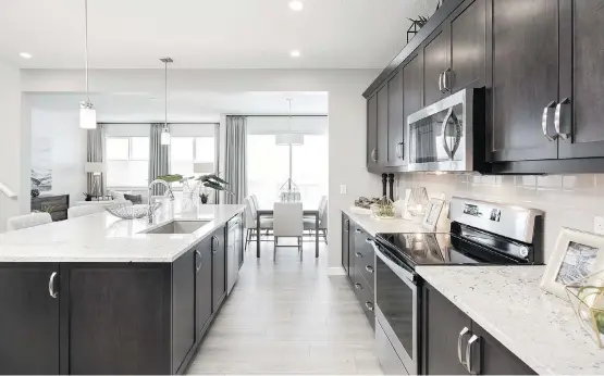  ?? PHOTOS: DUSTIN HOFFERT/DCPIX PHOTOGRAPH­Y ?? The spacious L-shaped kitchen in the Karma by Jayman Built is prominentl­y placed on the main level.