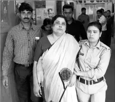  ??  ?? File photo shows Indian police officials escort Chakrabort­y (centre) from a police station in Jalpaiguri for a medical check up to a hospital in West Bengal, after her arrest as part of an alleged child traffickin­g scandal. — AFP photo