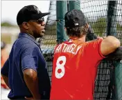  ?? JEFF ROBERSON / ASSOCIATED PRESS ?? Manager Don Mattingly talks with Michael Hill, the Marlins’ president of baseball operations, during Sunday’s practice in Jupiter.