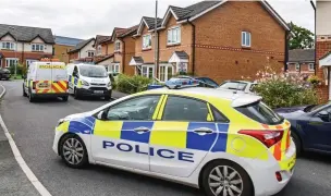  ??  ?? Scene of crime: Police seal off the home where a boy’s body was found