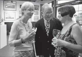  ?? DANA JENSEN/THE DAY ?? In this 2011 Day file photo, Diana Atwood-Johnson, left, visits with Maritime artist John Stobart, center, and Debra Petke, right, president of Lyme Academy College of Fine Arts, at a reception at The Gallery At Firehouse Square in New London.