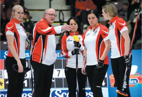  ?? CP PHOTO ?? Team Canada lead Raunora Westcott, left, coach Ron Westcott, skip Michelle Englot, third Kate Cameron and second Leslie Wilson discuss strategy during a timeout on Friday at the Scotties Tournament of Hearts in Penticton.