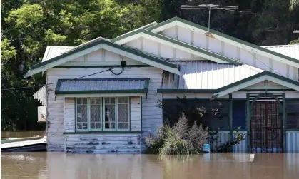  ?? Photograph: Jono Searle/EPA ?? Residents in Brisbane were let down by delays in getting emergency messages out during this year’s floods.