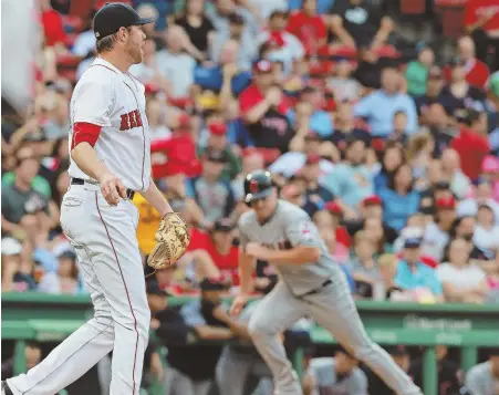  ?? STaff phoTos by MaTT wesT ?? CAN’T TOUGH IT OUT: Doug Fister reacts after giving up a hit during a three-run second inning last night at Fenway. After the Red Sox rallied to tie, Fister and Heath Hembree each gave up home runs to the Indians’ Edwin Encarnacio­n (right, with Jose...