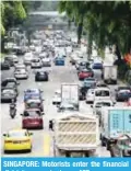  ?? —AFP ?? SINGAPORE: Motorists enter the financial district area yesterday.