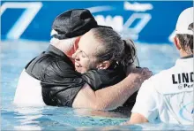  ?? ALEX GALLARDO THE ASSOCIATED PRESS ?? Pernilla Lindberg hugs her father, Jan Lindberg, after jumping into the pond following her win over Inbee Park at the ANA Inspiratio­n.