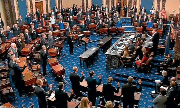  ?? AP ?? Presiding officer Supreme Court Chief Justice John Roberts swears in members of the Senate for the impeachmen­t trial against President Donald Trump at the US Capitol in Washington.