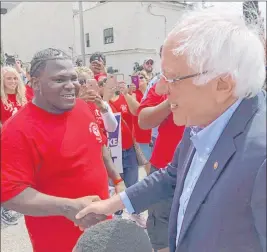  ?? Bruce Schreiner The Associated Press ?? Democratic presidenti­al candidate Sen. Bernie Sanders meets with striking telecommun­ications workers on Sunday during a stop in Louisville, Ky.