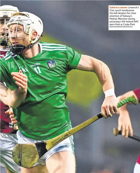  ?? EÓIN NOONAN/SPORTSFILE ?? Calm in a storm: Limerick’s Cian Lynch handpasses the ball despite the close attention of Galway’s Pádraic Mannion during yesterday’s All-Ireland SHC semi-final at Croke Park
