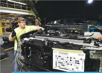  ??  ?? In this Oct 27, 2017 photo, a worker helps assemble a Ford truck at the Ford Kentucky Truck Plant, in Louisville, Ky. Yesterday, the Labor Department reported on US producer price inflation in October. —AP