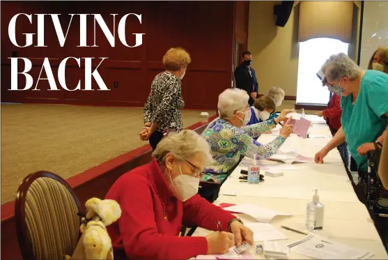  ?? SHEA SINGLEY — READING EAGLE ?? The Highlands of Wyomissing residents, seated from front to back, Eve Kimball, Jane Bitner, Carol Duchynski and Diana Kleiner volunteer at the two-day COVID-19vaccine clinic on Monday. Sponsored by The Highlands and Esterbrook Pharmacy in West Reading, the goal of the clinic is to vaccinate up to 1,300communi­ty members.