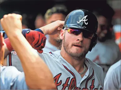  ?? AP - Patrick Semansky ?? Above: Braves third baseman Josh Donaldson celebrates with a teammate after hitting the go-ahead home run in the 10th inning of Wednesday’s game against the Nationals. The homer put Atlanta on top after its bullpen squandered the lead in the ninth. Below: Braves closer Luke Jackson is removed from the game by manager Brian Snitker in the bottom of the ninth.