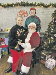  ?? COURTESY PHOTO ?? Karen Thornhill, left, Santa and Deb Landis
