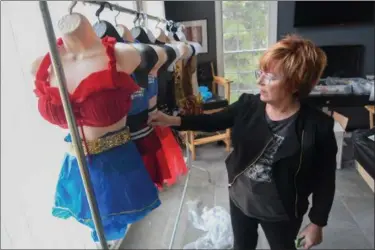  ?? ERIC BONZAR — THE MORNING JOURNAL ?? Peggy Sinibaldi inspects one of her costume creations which will be featured during the Rock for Water 2017: Recycled Fashion Show at the Lorain Palace Theater on April 29, 2017.