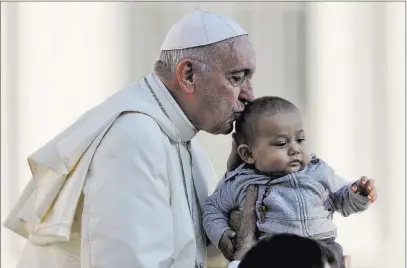  ?? Gregorio Borgia ?? The Associated Press Pope Francis kisses a child as he arrives in St. Peter’s Square for his weekly general audience Wednesday at the Vatican.