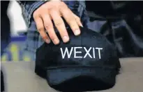  ?? REUTERS/TODD KOROL ?? A supporter holds his Wexit hat while attending a rally for Wexit Alberta, a separatist group seeking federal political party status in Calgary.