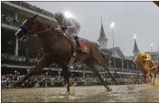  ?? MORRY GASH — THE ASSOCIATED PRESS FILE ?? Mike Smith rides Justify to victory during the 144th running of the Kentucky Derby horse race at Churchill Downs in Louisville, Ky on May 5, 2018.