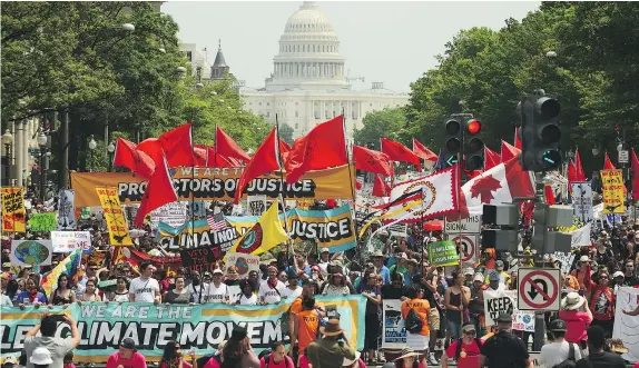  ?? — GETTY IMAGES ?? People march from the U.S. Capitol to the White House to protest U.S. President Donald Trump’s environmen­tal policies on Saturday in Washington. Demonstrat­ors in dozens of U.S cities gathered to demand a clean-energy economy.