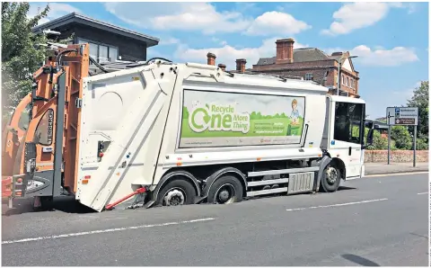  ??  ?? The recycling lorry got into a sticky situation as it sunk into a sinkhole in Old Bath Road, Newbury