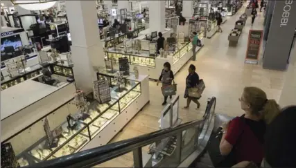  ?? BENJAMIN NORMAN, NEW YORK TIMES ?? People shop in the Lord & Taylor department store in Manhattan. As of Christmas 2018, Lord and Taylor will occupy less than one quarter of the building.