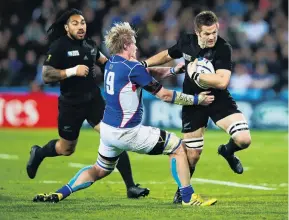  ??  ?? Best of the best . . . All Black captain Richie McCaw pushes off Renaldo Bothma against Namibia in London during the 2015 World Cup match. Ma’a Nonu is backing up.