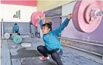  ??  ?? Iraqi weightlift­er Roqaya Ahmed, 12, trains at a club in Sadr City, east of Baghdad. — AFP photos