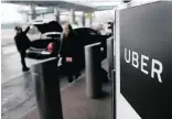  ?? ?? A sign marks a pick-up point for the Uber car service at LaGuardia Airport in New York.