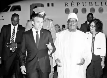  ??  ?? Macron (left) talks with Mali’s President Ibrahim Boubacar Keita as he arrives at Modibo Keita internatio­nal airport in Bamako. — Reuters photo