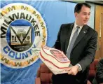  ?? JOURNAL SENTINEL FILES MILWAUKEE JOURNAL SENTINEL ?? Scott Walker receives a cake Nov. 3, 2010, the day after his 43rd birthday and election win.