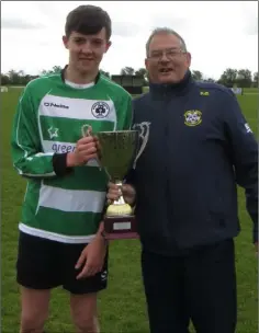  ??  ?? Fixtures Secretary Simon Barnes presenting the Under-16 Division 4 trophy to Gorey Celtic captain Ryan Keogh.