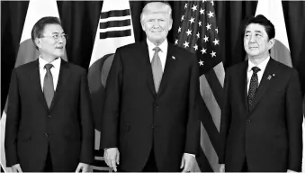  ??  ?? A file photo of US President Donald Trump with South Korean President Moon Jae-In ( left) and Japanese Prime Minister Shinzo Abe. Japan is home to six US navy vessels and the US Army’s Second Infantry Division is based in South Korea