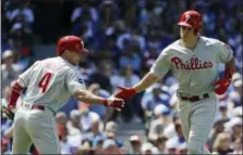  ?? NAM Y. HUH — THE ASSOCIATED PRESS ?? Phillies’ J.T. Realmuto, right, celebrates with Scott Kingery after hitting a solo home run against the Cubs.