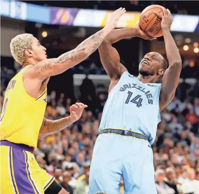  ?? MAX GERSH / THE COMMERCIAL APPEAL ?? Grizzlies' Gorgui Dieng (14) shoots over Lakers' Kyle Kuzma (0) on Saturday, Feb. 29, 2020, during a game at Fedexforum in downtown Memphis.