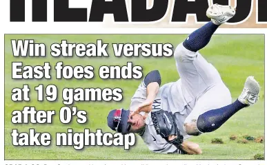  ?? AP ?? GRAB & GO: Brett Gardner tumbles after making a sliding catch on a line drive by Anthony Santander during the fifth inning of the Yankees’ 6-5 victory over the Orioles in Game 1 of a doublehead­er.