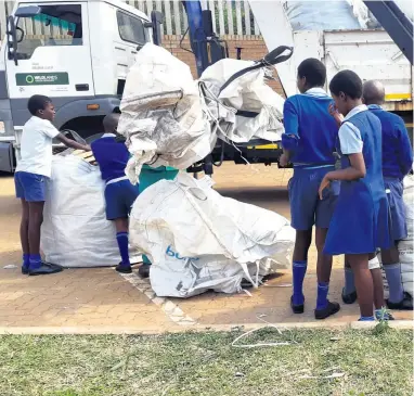  ??  ?? Learners at Ingweni Primary keep the school clean by recycling paper